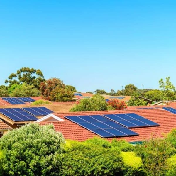Residential neighborhood rooftops outfitted with clean home solar panel systems under the Queensland sun.